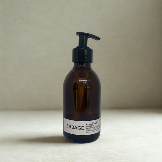 Brown bottle Herage Natural Soap with pump dispenser on a beige background
