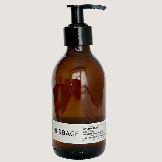 Brown bottle with black pump and white label on a light gray background