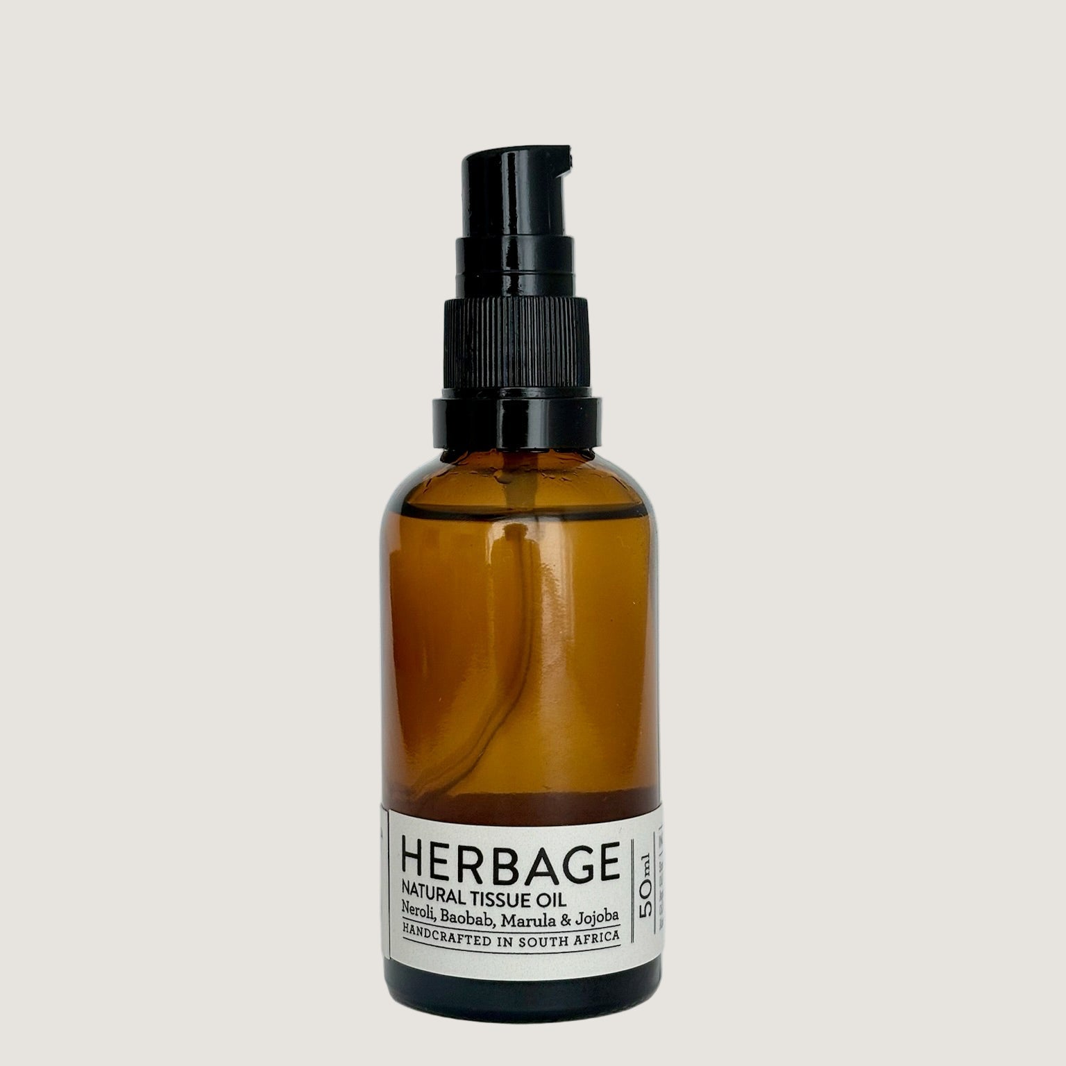 Brown glass bottle with black spray nozzle on a light gray background